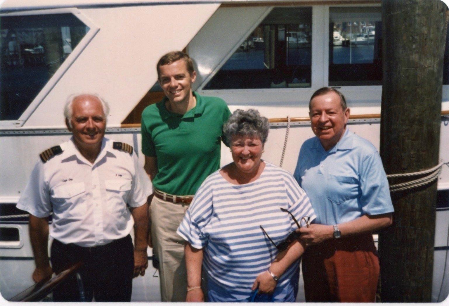 Captain Guy, in uniform, with family at the boat